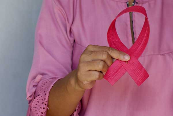 women holding breast cancer ribbion